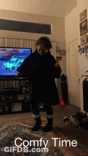 A Person Standing In Front Of A Television With The Words " Comfy Time " Written Below Them GIF