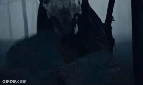 A Person Standing In The Dark With A Sword GIF