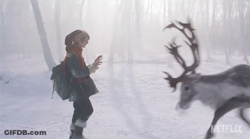A Person Standing In The Snow Next To A Reindeer With Netflix Written On The Bottom GIF