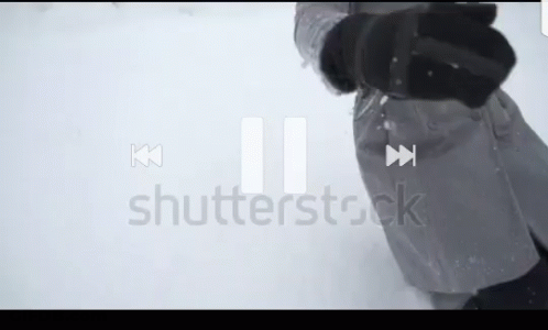 A Person Standing In The Snow With A Shutterstock Logo In The Corner GIF
