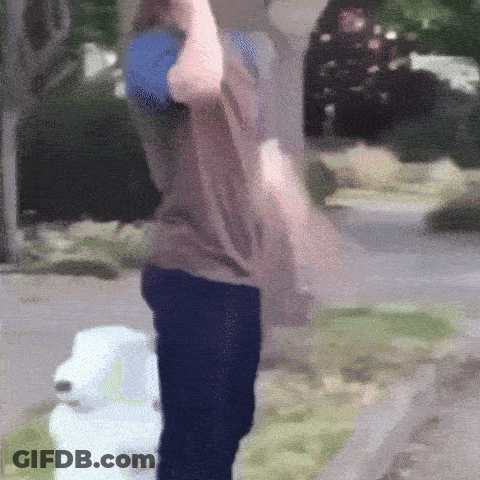 A Person Standing Next To A Fire Hydrant Holding A Blue Ball GIF