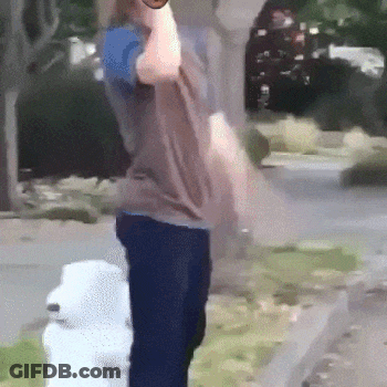 A Person Standing Next To A Fire Hydrant Holding A Bottle GIF
