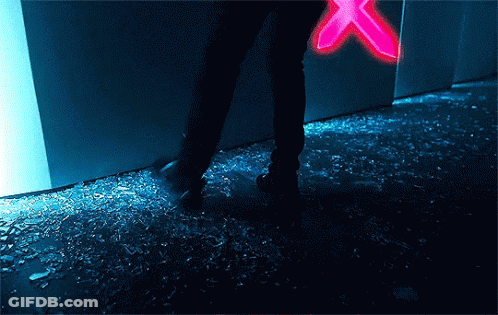A Person Standing On A Broken Glass Floor With A Neon Sign In The Background . GIF