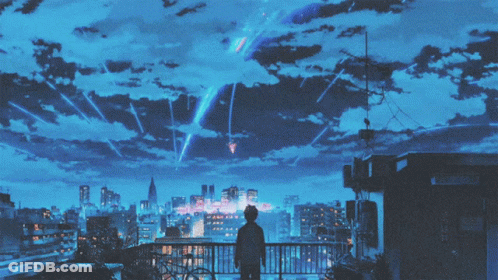 A Person Standing On A Building Looking Up At The Sky GIF