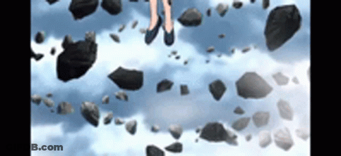 A Person Standing On A Pile Of Rocks In The Sky . GIF