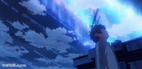 A Person Standing On A Roof Looking Up At A Starry Sky GIF
