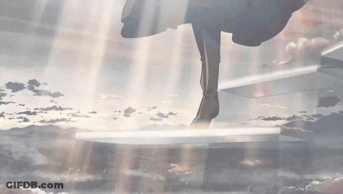 A Person Standing On A Staircase With The Sun Shining Through GIF