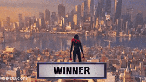 A Person Standing On Top Of A Building With The Word Winner Above Them GIF