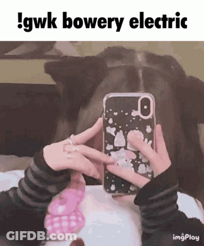A Person Taking A Picture Of Themselves With A Phone Case That Says Gwk Bowery Electric GIF