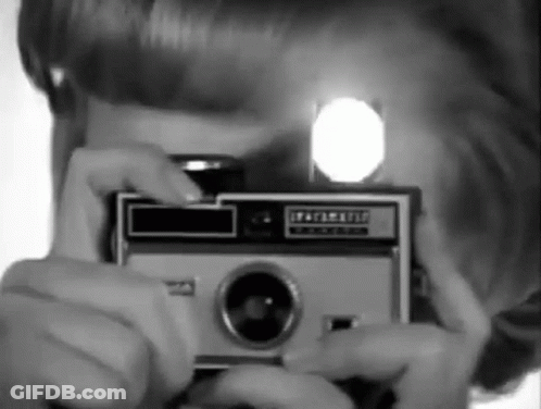 A Person Taking A Picture With A Kodak Camera GIF