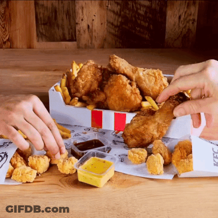 A Person Taking A Piece Of Fried Chicken Out Of A Box That Says Kfc GIF