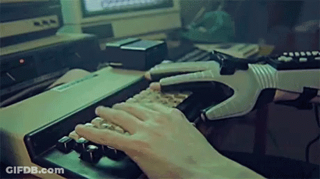 A Person Typing On A Keyboard With A Glove On GIF