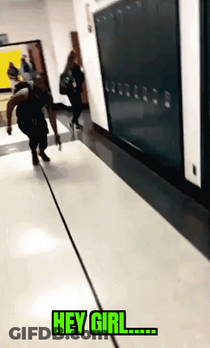 A Person Walking Down A Hallway With The Words " Hey Girl " On The Floor GIF