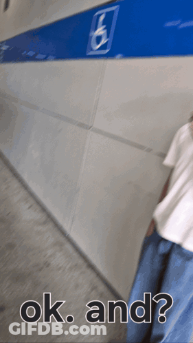 A Person Walking Down A Hallway With The Words Ok And GIF