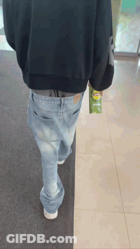 A Person Walking With A Bag Of Lays Chips In Their Hand GIF