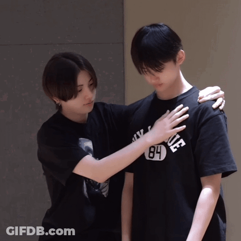A Person Wearing A 84 T-Shirt Holds Another Person 'S Shoulder GIF