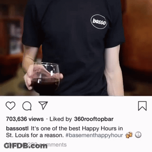 A Person Wearing A Basso Shirt Holds A Glass Of Wine GIF