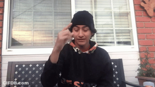 A Person Wearing A Black Beanie And A Black Sweatshirt With The Word Design On The Front GIF