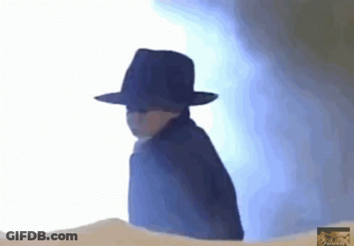 A Person Wearing A Black Hat And A Cape GIF