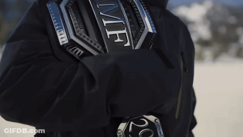 A Person Wearing A Black Jacket With A Silver Emblem On The Back That Says ' Ufc ' GIF
