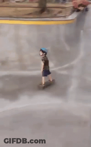 A Person Wearing A Blue Helmet Rides A Skateboard Down A Ramp GIF