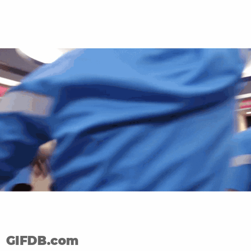 A Person Wearing A Blue Jacket With Reflective Stripes GIF