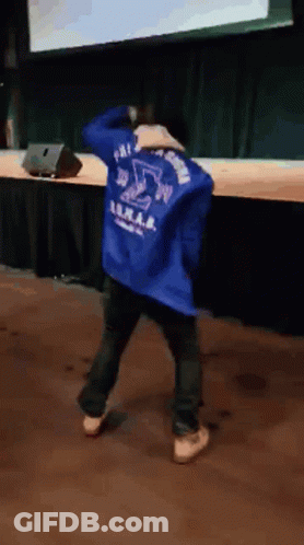 A Person Wearing A Blue Jacket With The Letter S On The Back GIF