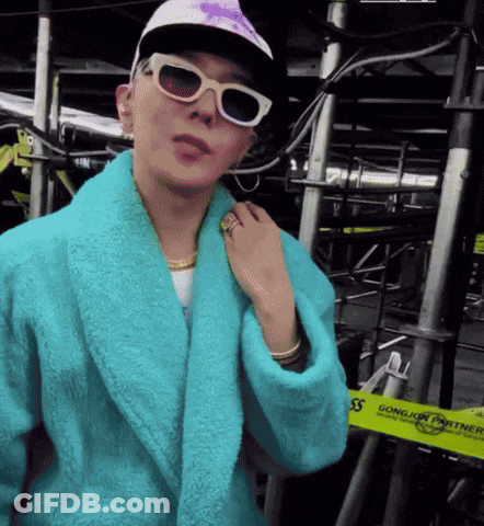 A Person Wearing A Blue Robe And Sunglasses Stands In Front Of A Yellow Tape That Says Gongjin Power GIF