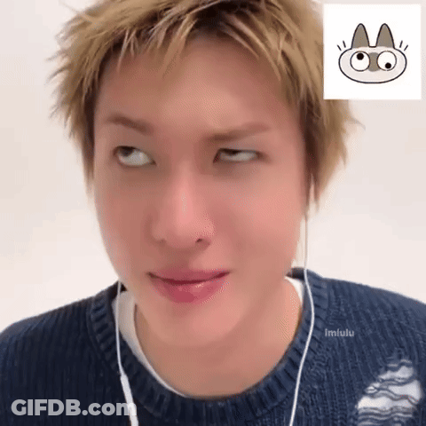 A Person Wearing A Blue Sweater And Earphones Making A Face GIF