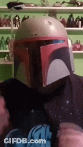 A Person Wearing A Boba Fett Helmet And A Star Wars T-Shirt GIF