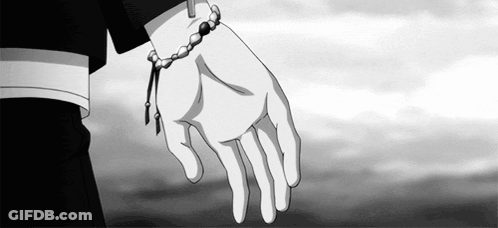 A Person Wearing A Bracelet On Their Wrist Is Holding Another Person 'S Hand In A Black And White Photo . GIF