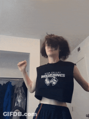 A Person Wearing A Crop Top With Utah Valley Wolverines On It GIF