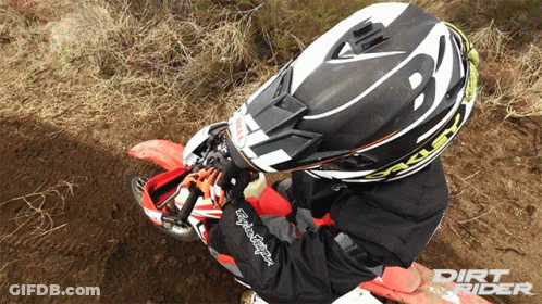 A Person Wearing A Dirt Rider Helmet Is Riding A Dirt Bike GIF