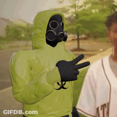 A Person Wearing A Gas Mask And A Green Hoodie GIF
