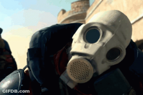 A Person Wearing A Gas Mask Is Standing In The Desert GIF