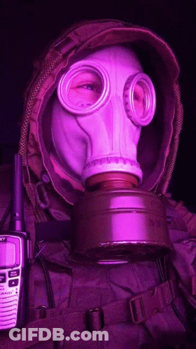 A Person Wearing A Gas Mask Next To A Walkie Talkie That Says Sony GIF