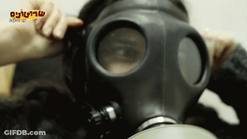 A Person Wearing A Gas Mask With A Foreign Language On The Bottom Right Corner GIF