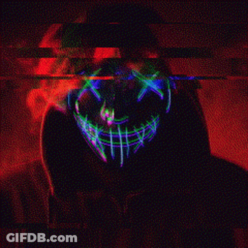 A Person Wearing A Glow In The Dark Mask With A Skull On It . GIF