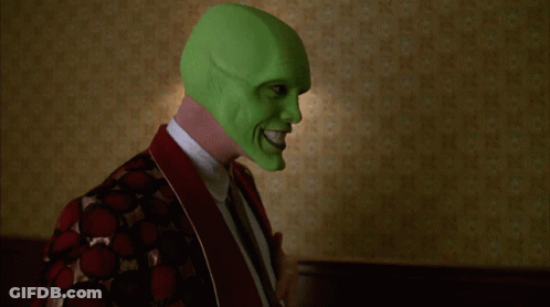 A Person Wearing A Green Mask Is Standing In Front Of Two Lamps GIF