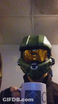 A Person Wearing A Halo Helmet Is Holding A Coffee Mug GIF
