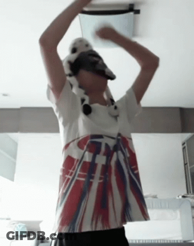 A Person Wearing A Hat And A T-Shirt With A British Flag Design On It GIF
