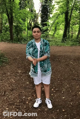 A Person Wearing A Hawaiian Shirt And White Shorts GIF