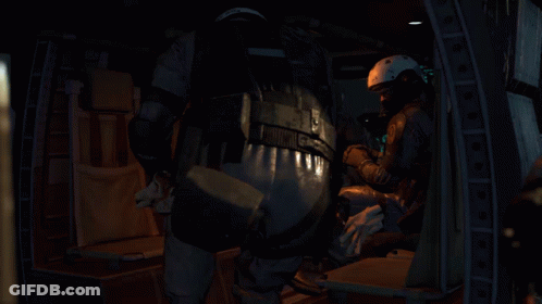 A Person Wearing A Helmet And A Microphone Is Sitting Down . GIF