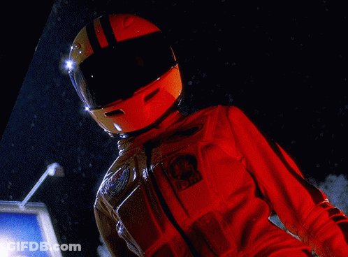 A Person Wearing A Helmet And A Red Jacket With A Patch That Says Nasa On It GIF