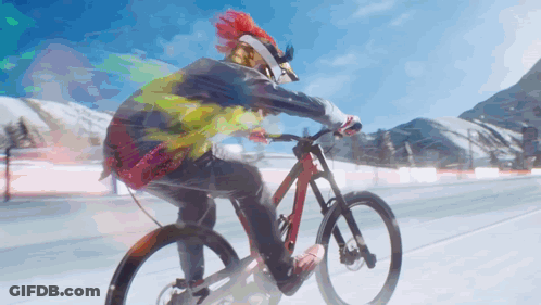 A Person Wearing A Helmet And Goggles Is Riding A Bike GIF
