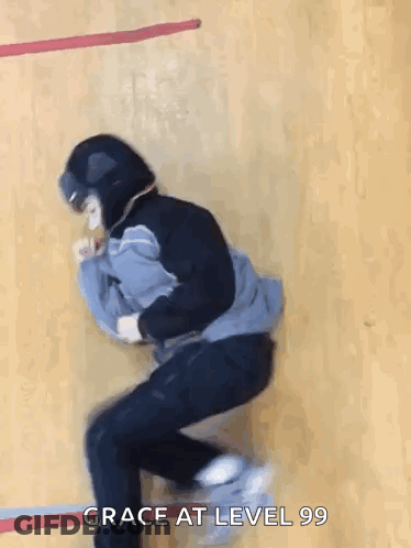 A Person Wearing A Helmet Is Jumping In The Air With The Words Grace At Level 99 Below Them . GIF