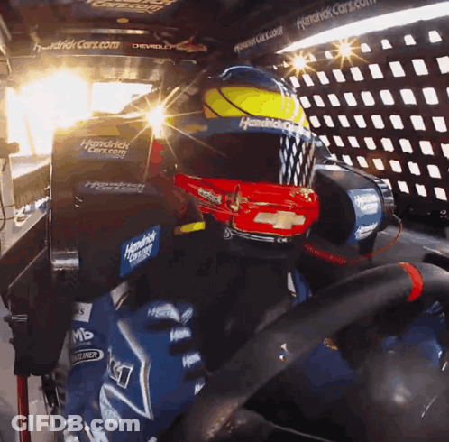 A Person Wearing A Helmet That Says Hendrick Racing On It GIF