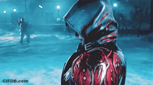 A Person Wearing A Hooded Jacket With A Red And Black Design On It Is Standing In The Snow . GIF