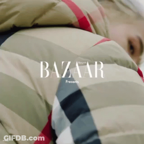 A Person Wearing A Jacket With The Word Bazaar Written On It GIF
