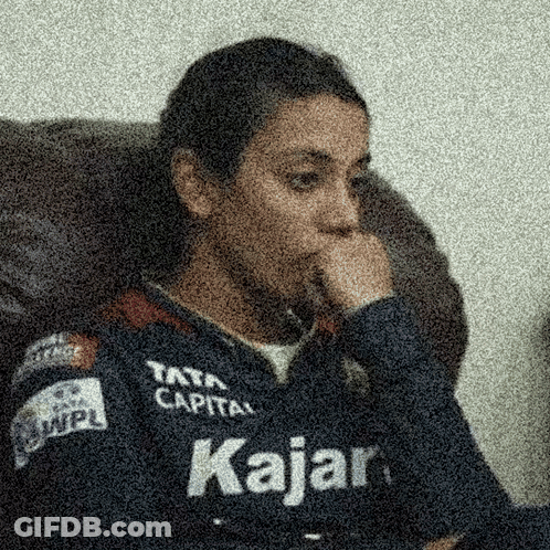 A Person Wearing A Kajar Shirt Is Sitting In A Chair GIF